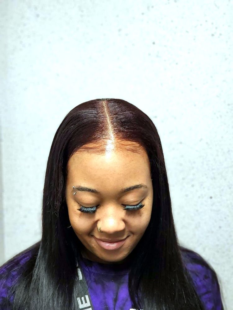 Silky straight sew-in with a middle part