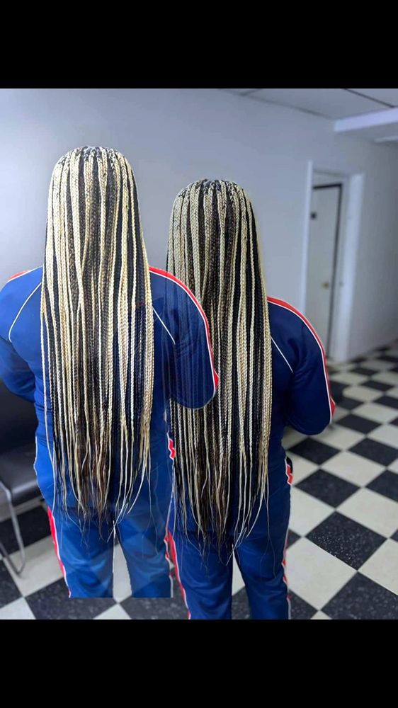 Two clients with long blonde-highlighted braids