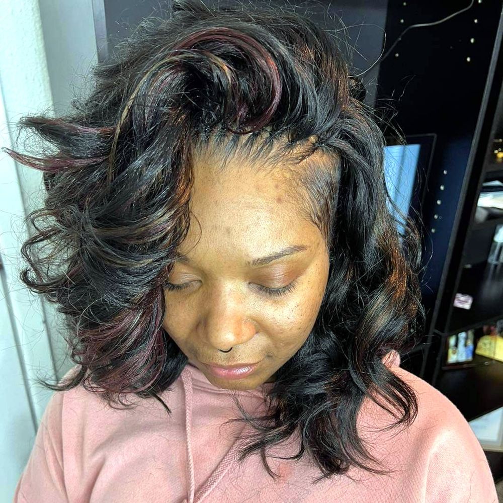 Sew-in with loose curls and burgundy highlights