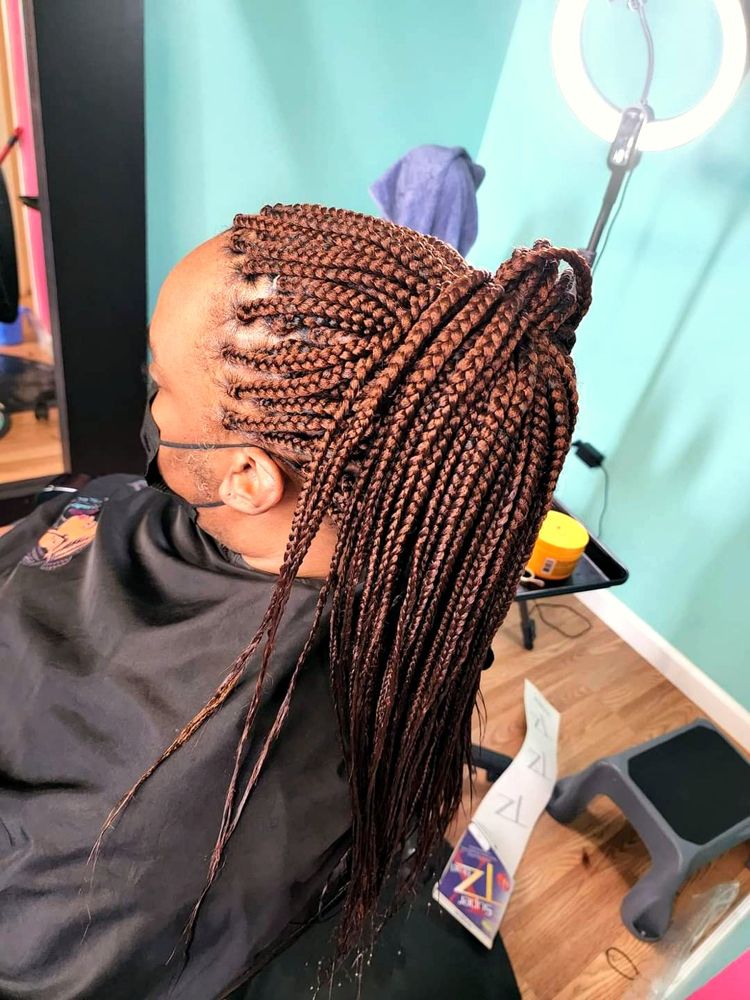 Copper box braids in a high ponytail